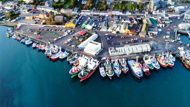 aerial photograph of busy fishing port with trawlers berthed